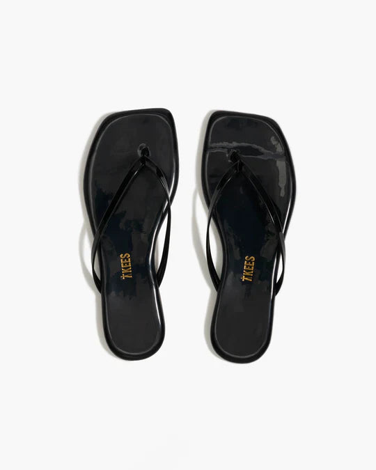 Black flip-flops with a brand logo on a white background