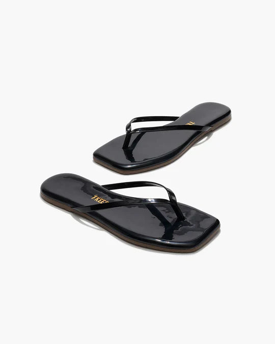 Black flip-flops with a brand logo on a white background