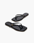 Black flip-flops with a brand logo on a white background