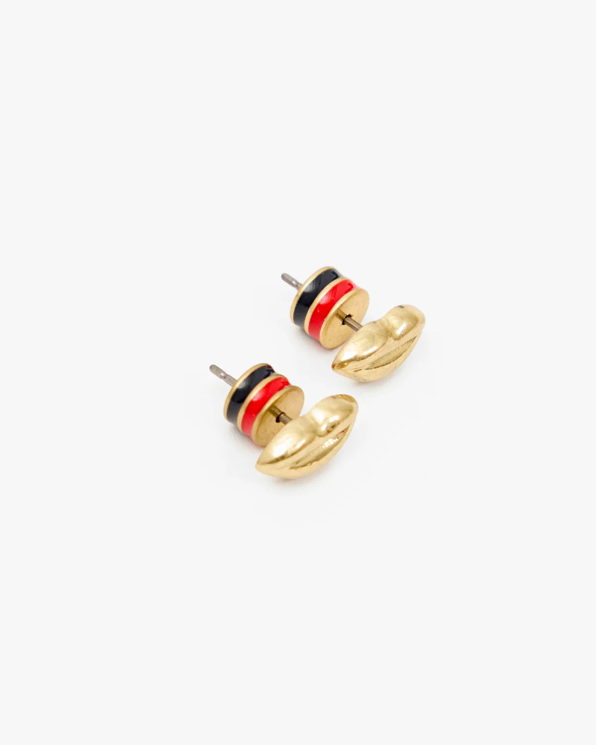 A pair of gold-tone stud earrings with a small circular disc featuring black, red, and white stripes, shown on a clean white background.