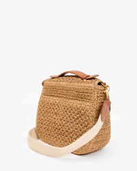 Woven handbag with leather accents on a white background