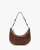 A brown snakeskin-patterned crescent shoulder bag with a black strap and gold-tone hardware, shown against a plain white background.
