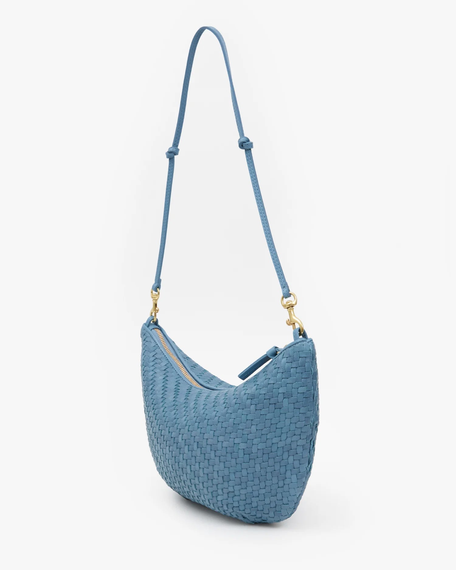 Blue woven handbag with a strap on a white background