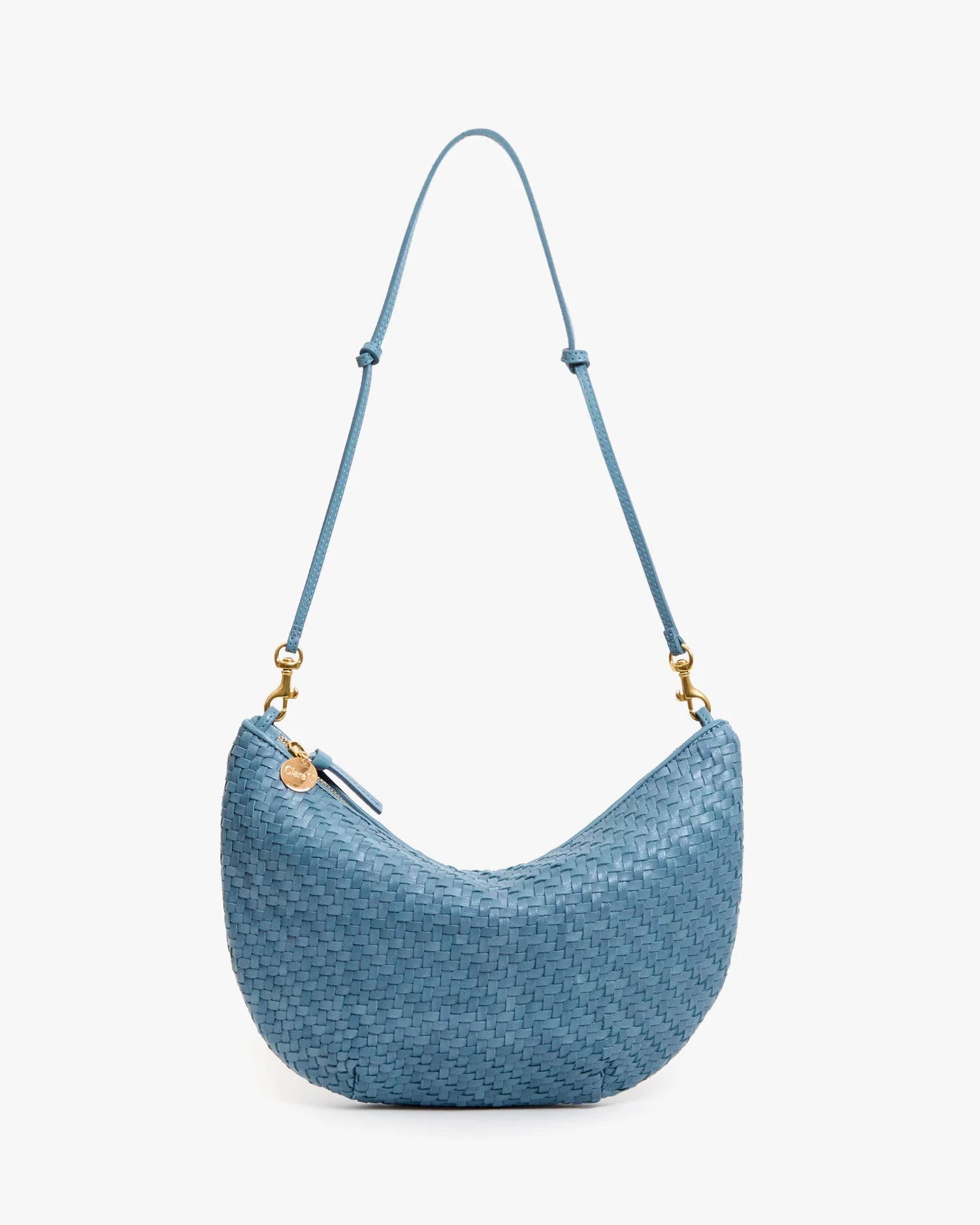 Blue woven handbag with a strap on a white background
