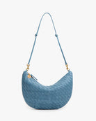 Blue woven handbag with a strap on a white background