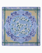 Decorative placemat with blue floral design on a beige background