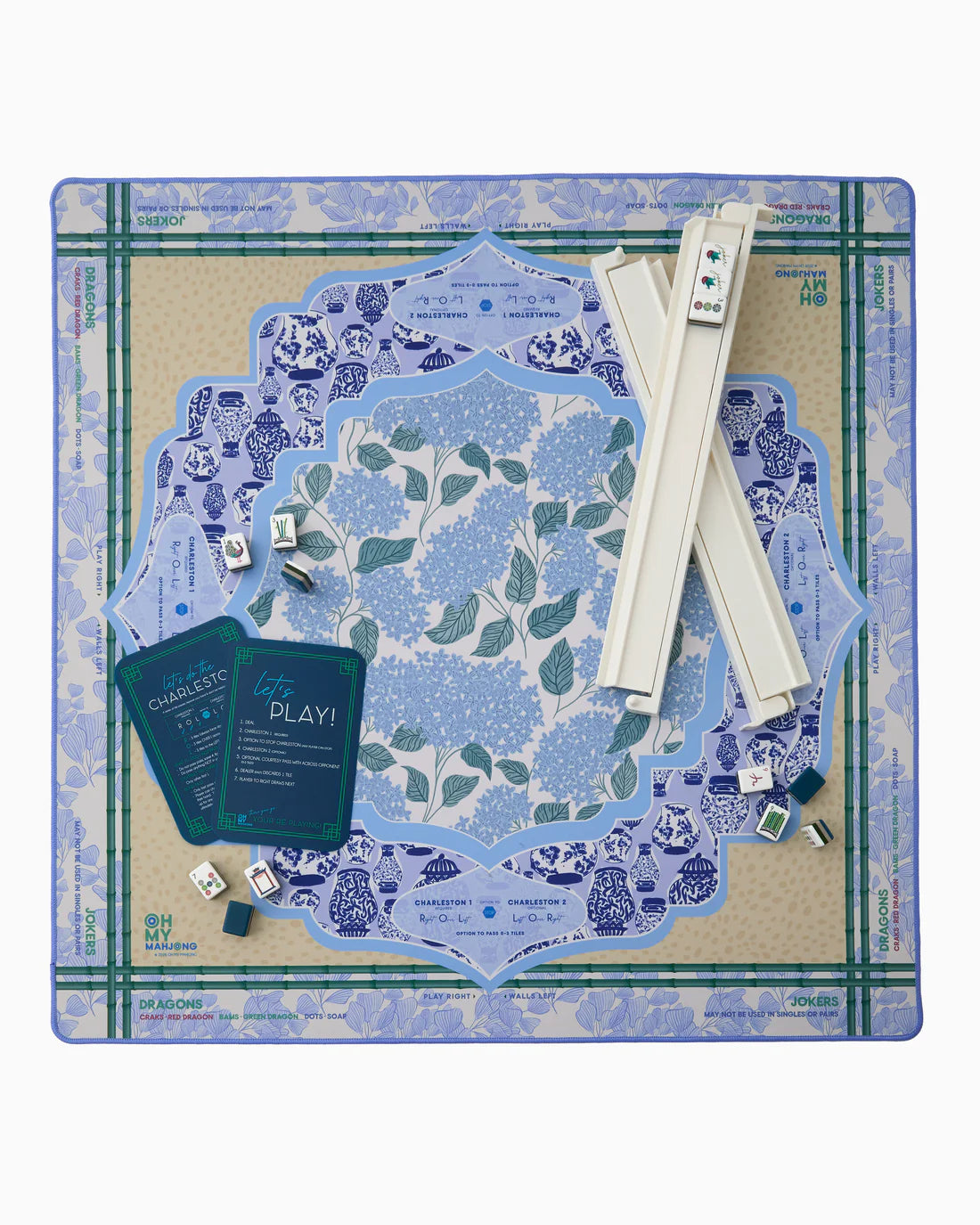 Board game set with blue and green floral pattern on a cardboard base