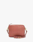 Pink woven handbag on a white background