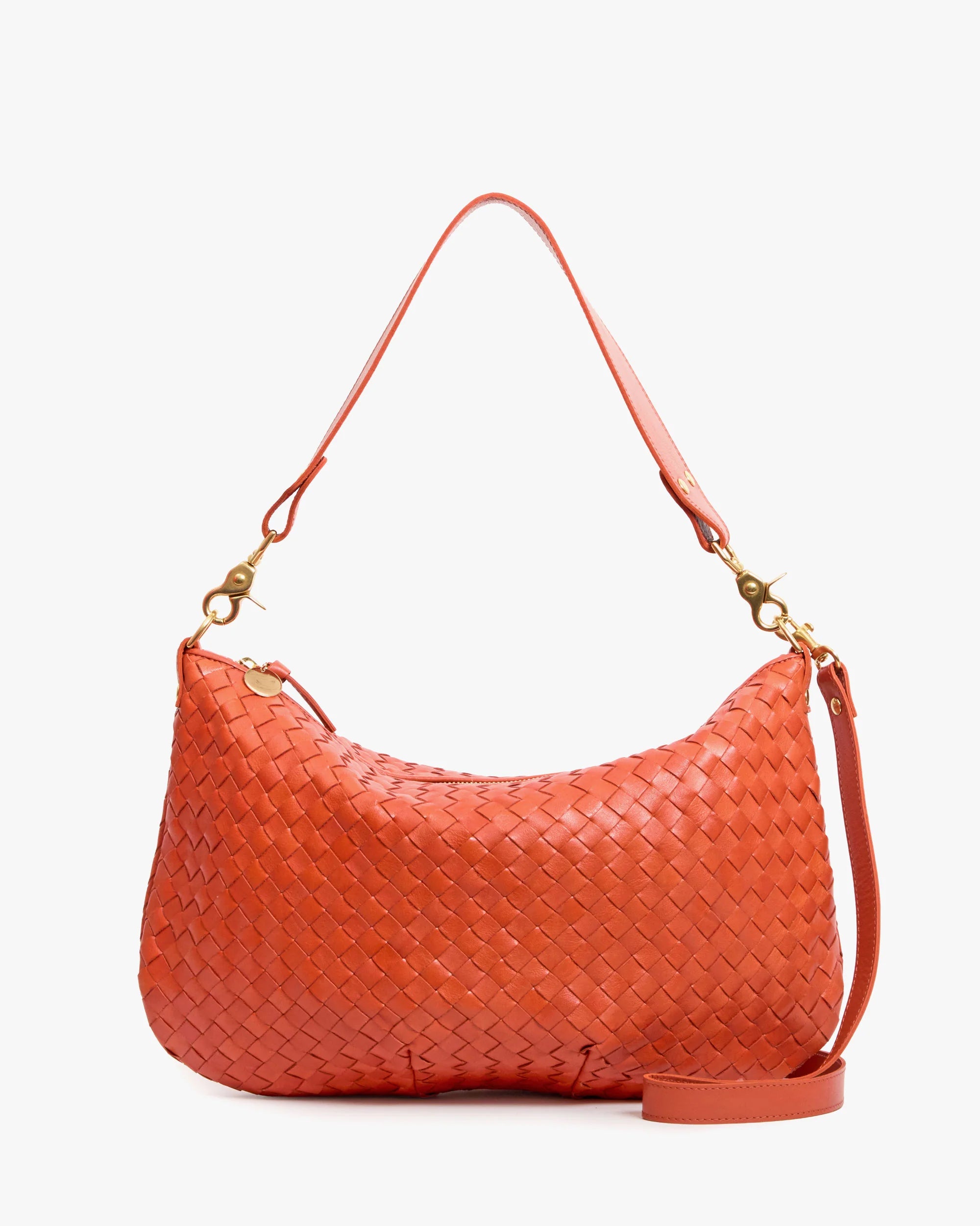 Orange woven handbag with a strap on a white background