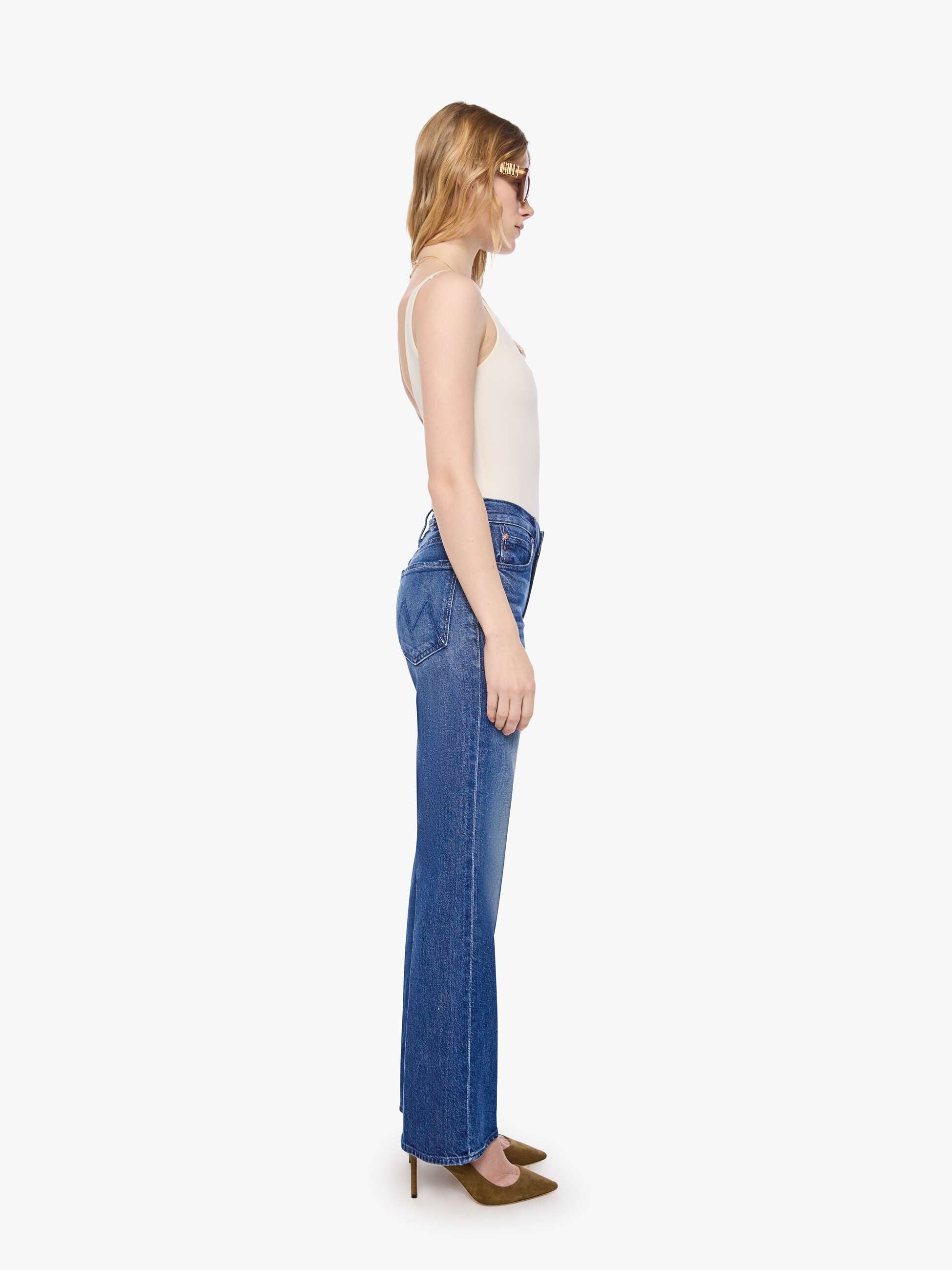 Woman wearing blue jeans on a white background