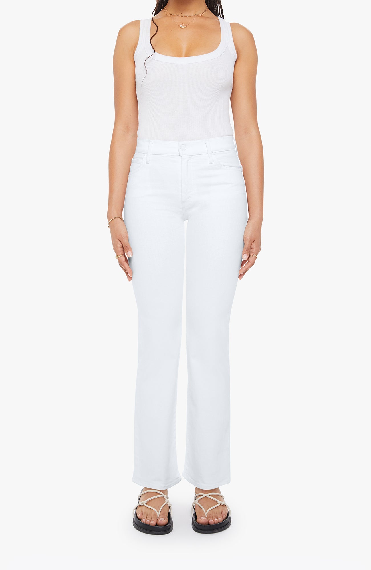 Person wearing a white sleeveless top and pants on a white background