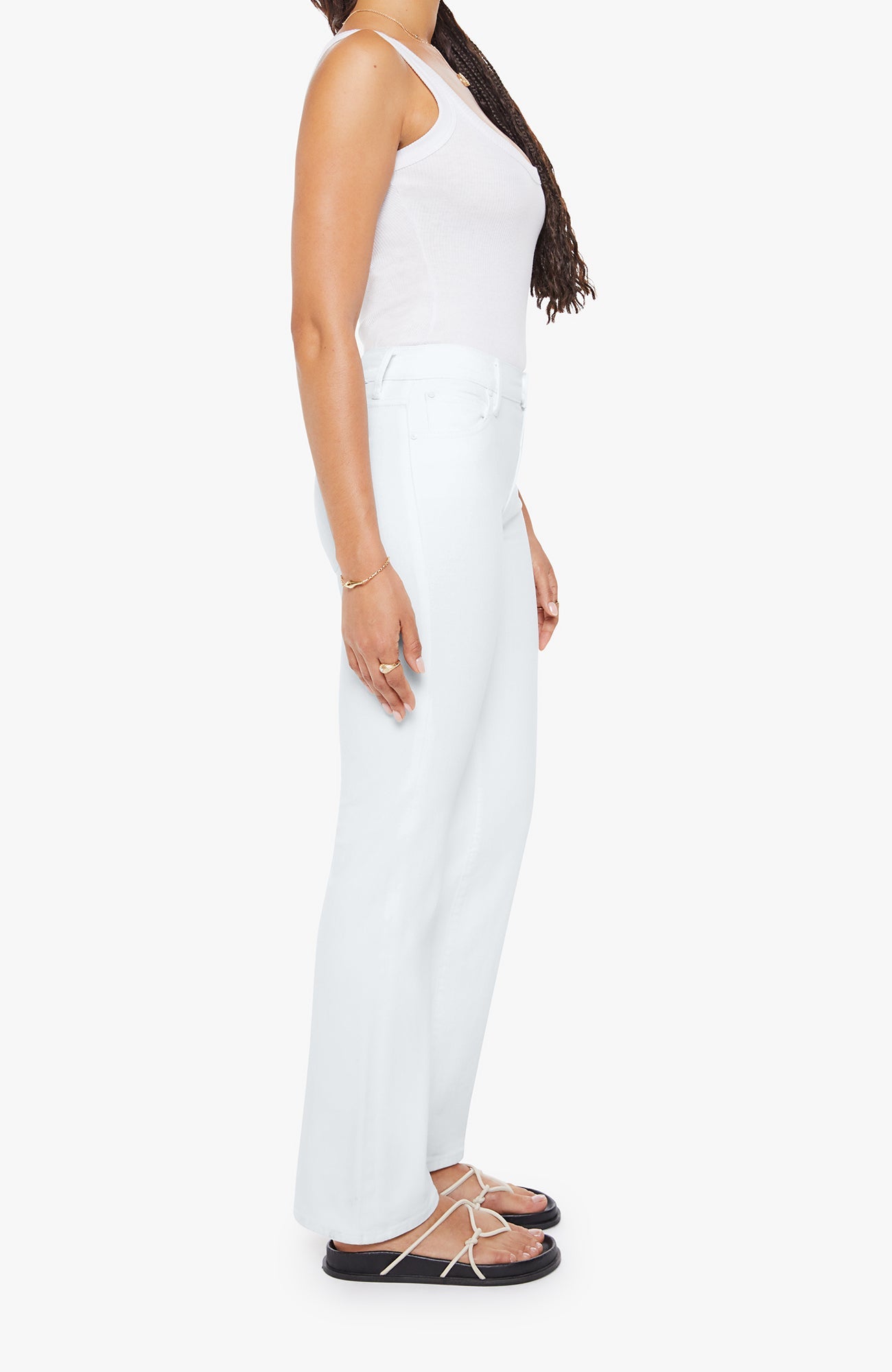 Person wearing a white sleeveless top and pants on a white background