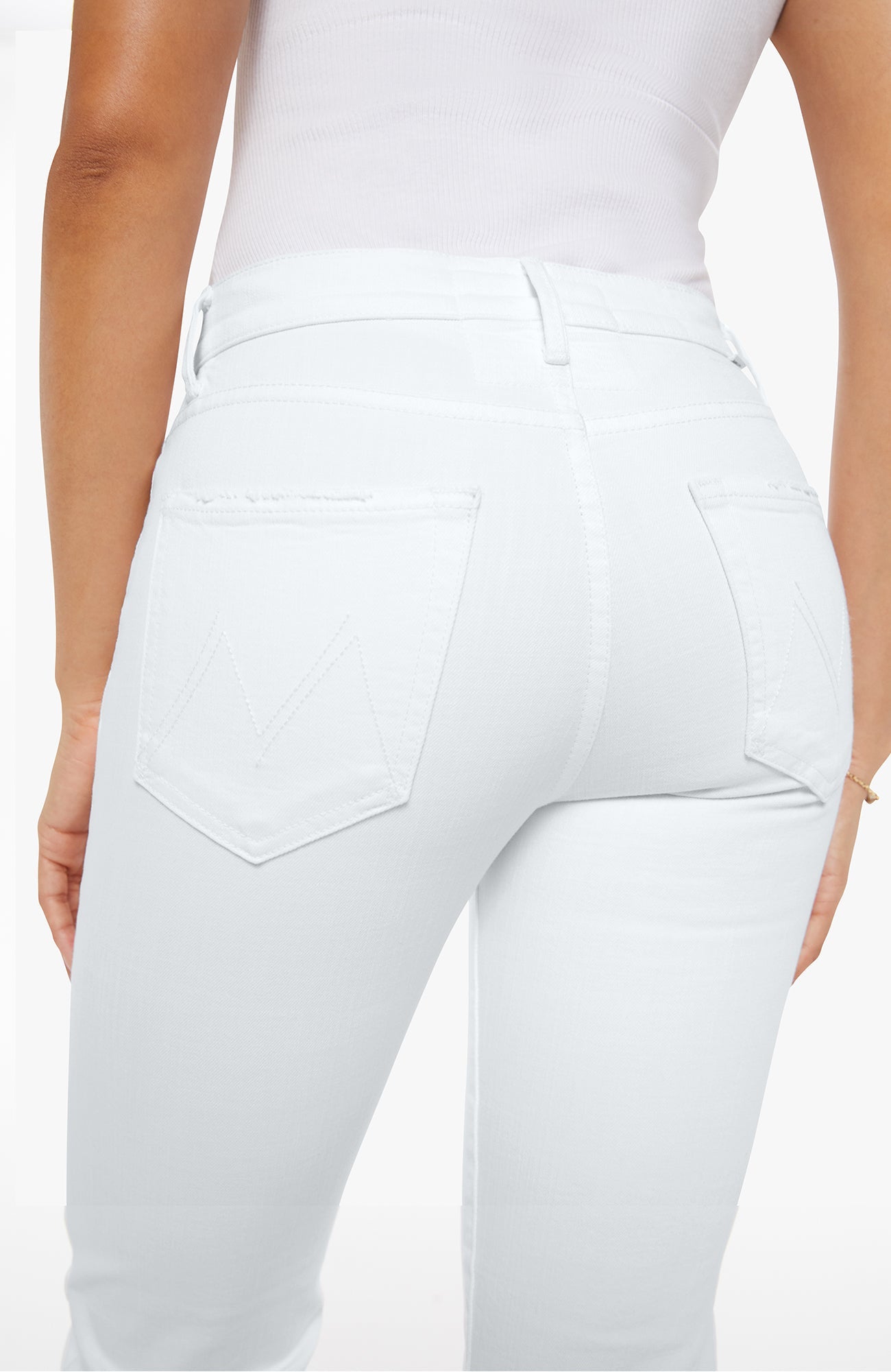 White pants worn by a person on a light gray background