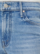 Close-up of blue denim jeans with a button and zipper detail.