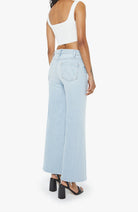 Light blue jeans worn by a person on a white background