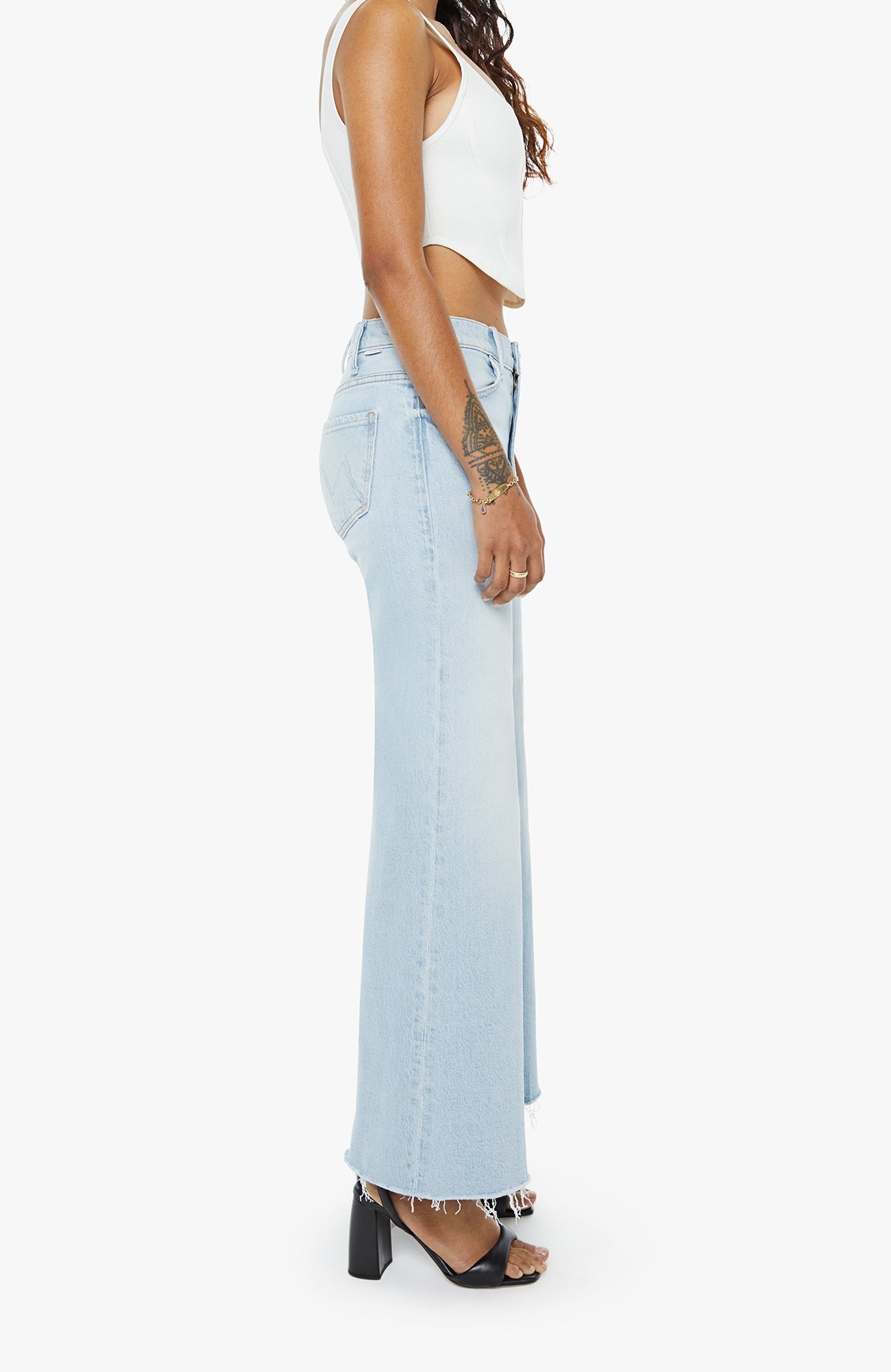 Light blue jeans worn by a person on a white background