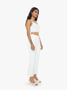 Woman wearing a white outfit on a white background