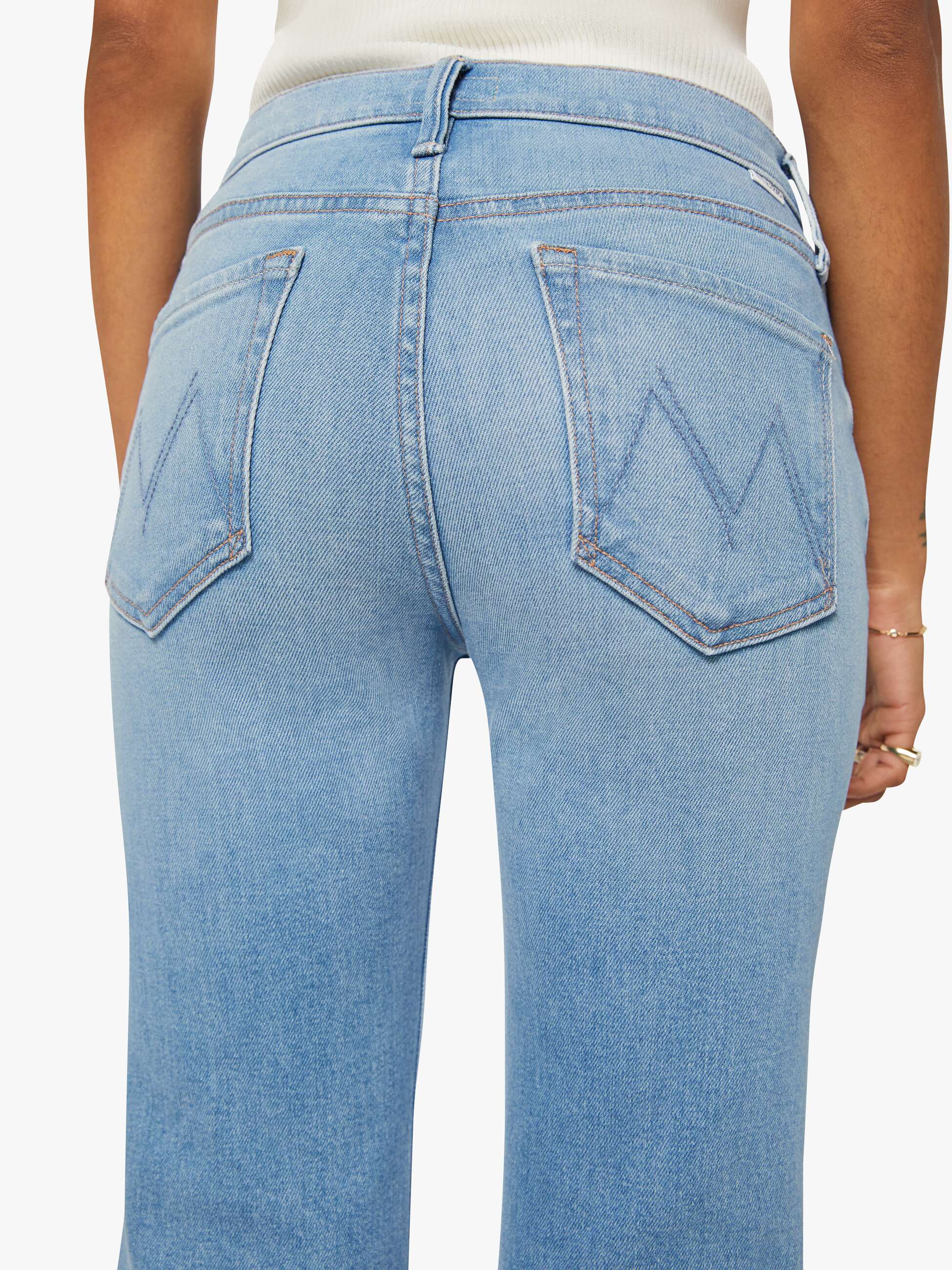 Light blue jeans with a brand logo on a white background