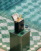 Ice chest with champagne bottles by a poolside
