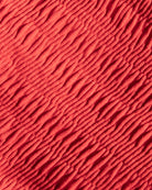 Close-up of red textured fabric with wavy pattern