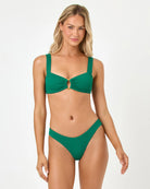 Woman wearing a green bikini on a white background