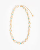 Necklace with gold chain and turquoise beads on a white background