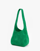 Green suede handbag on a white background