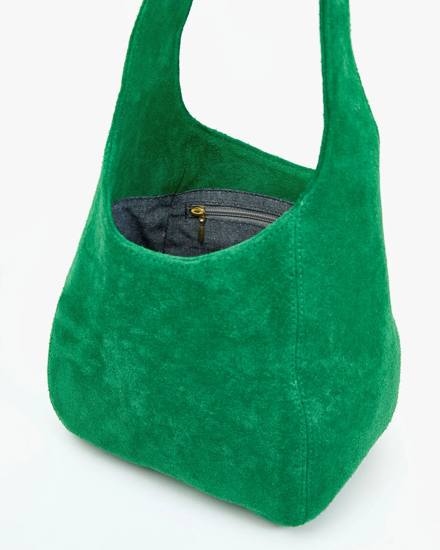 Green suede handbag on a white background
