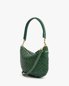 Green woven handbag with a shoulder strap on a white background