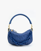 Blue woven handbag with chain detail on a white background