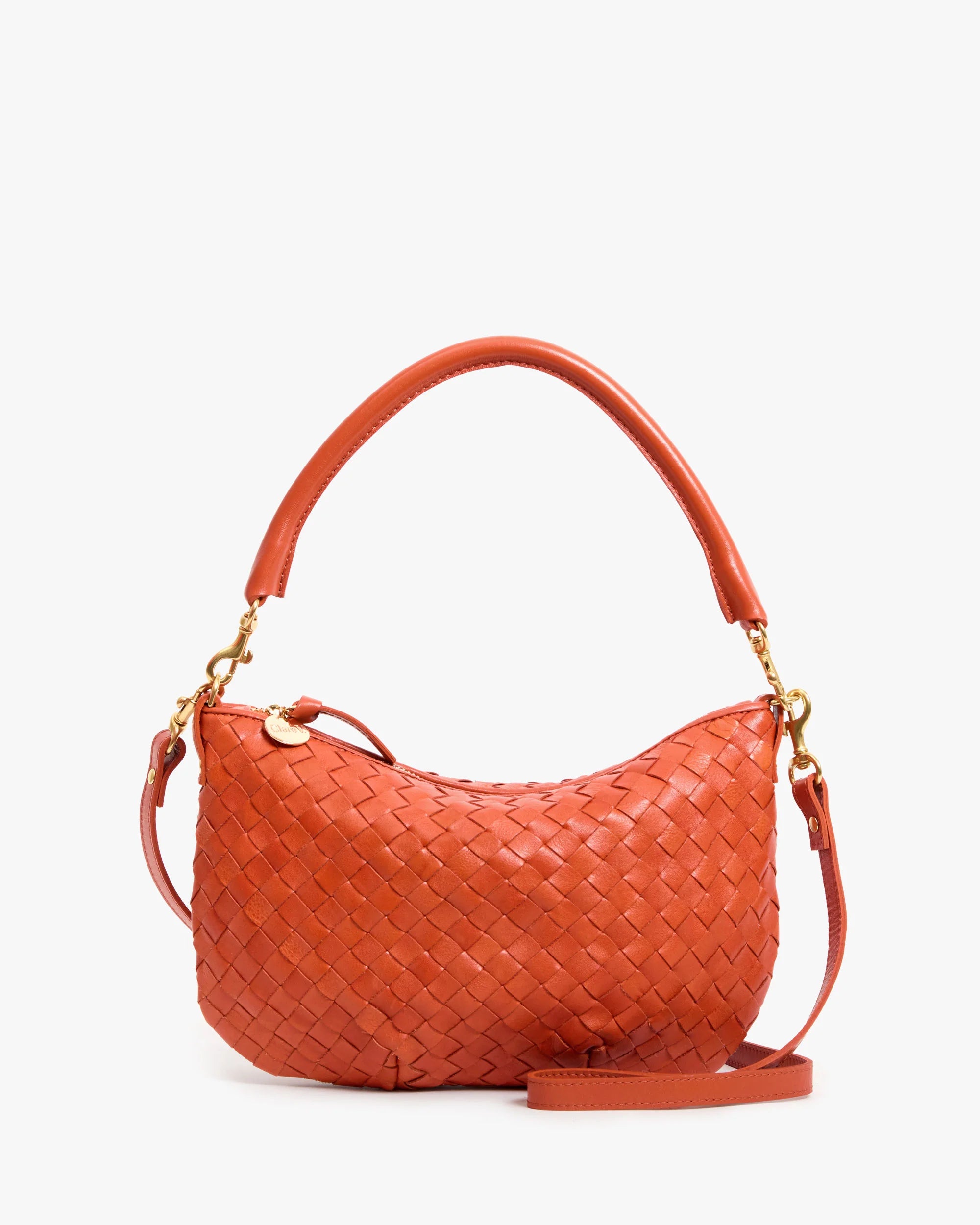 Orange woven handbag with gold accents on a white background