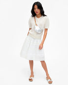 Woman wearing a white outfit with a white background
