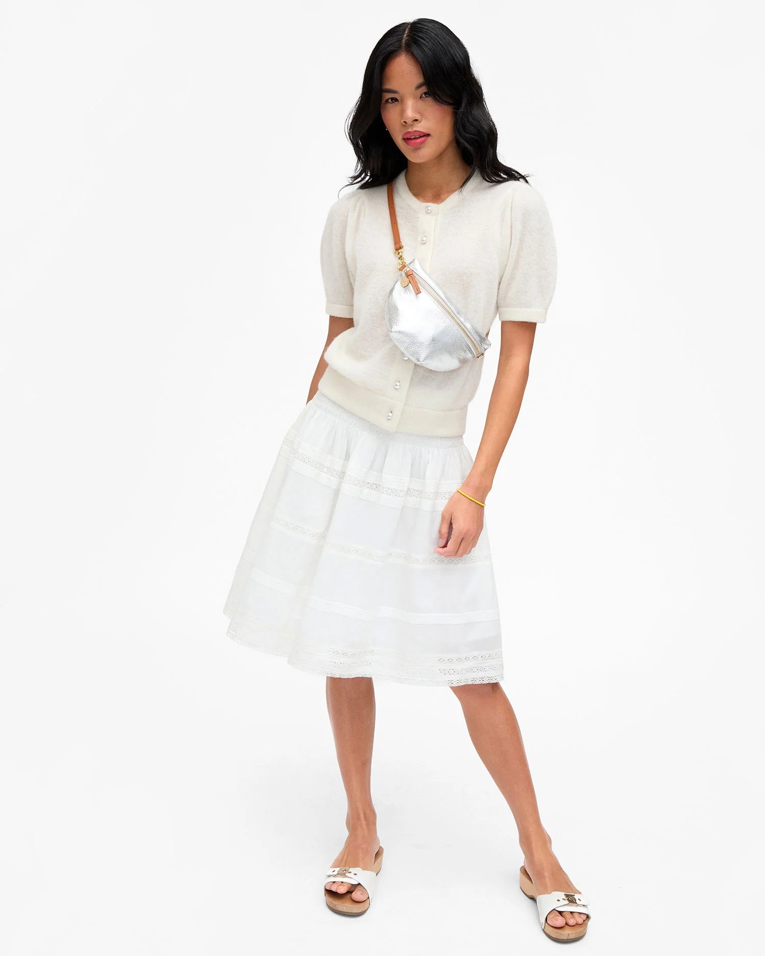 Woman wearing a white outfit with a white background