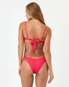 Woman wearing a red bikini with a white background