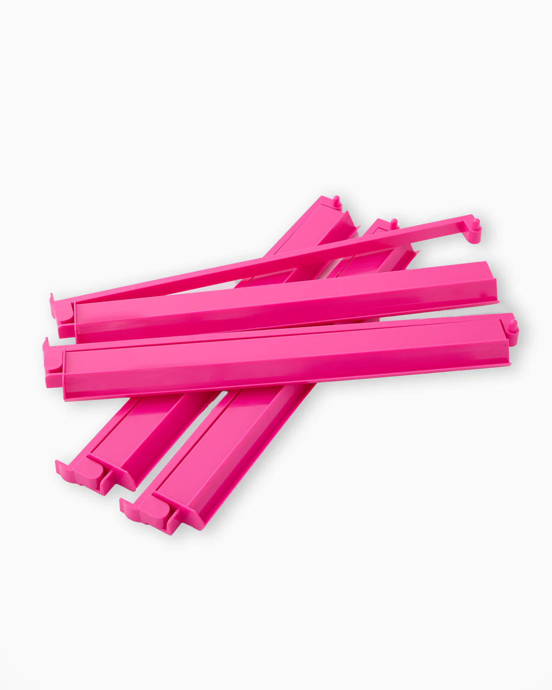 Stack of pink plastic straws on a white background