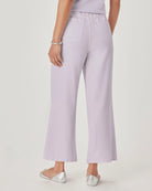 Person wearing light purple pants on a plain background