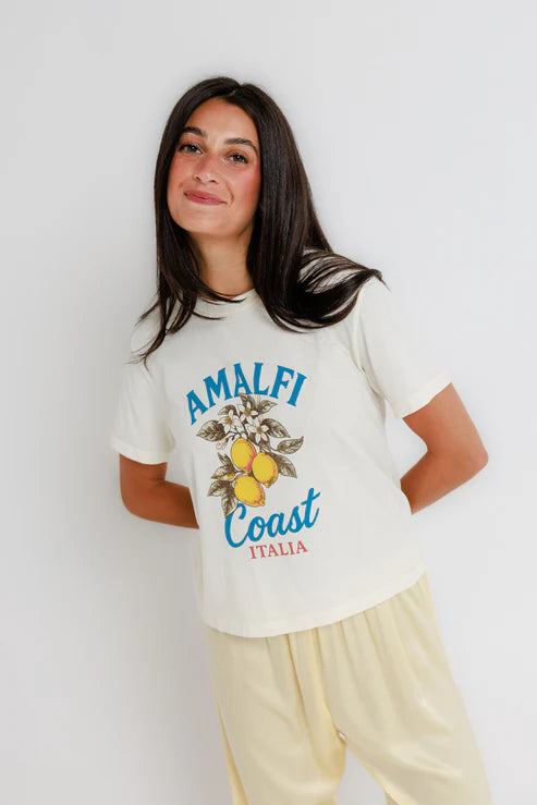 Woman wearing a 'Amalfi Coast Italia' t-shirt against a white background