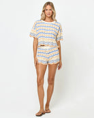 Woman wearing a striped outfit on a white background