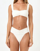 White bikini worn by a model on a white background