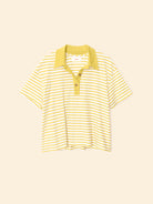 Yellow and white striped polo shirt on a beige background