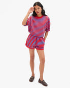 Woman wearing a red and blue striped outfit on a white background