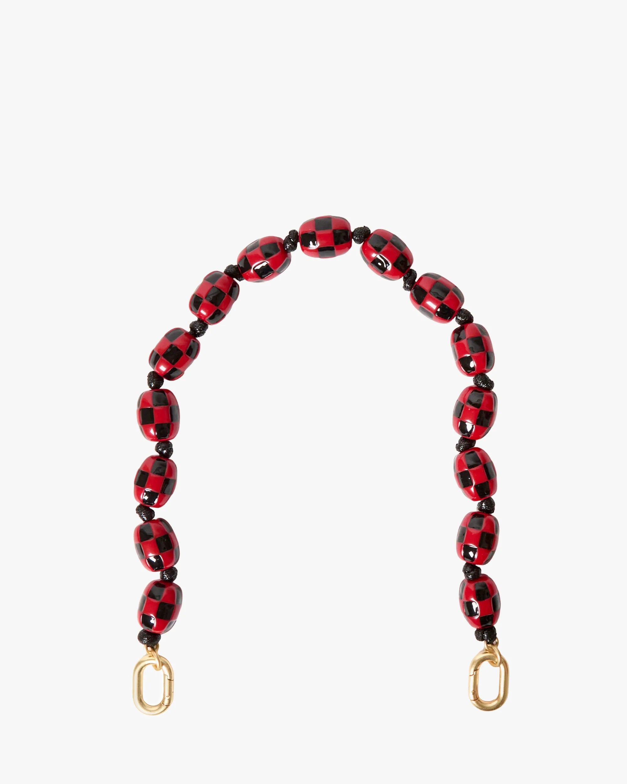 Red and black beaded bag strap with gold hardware on a white background