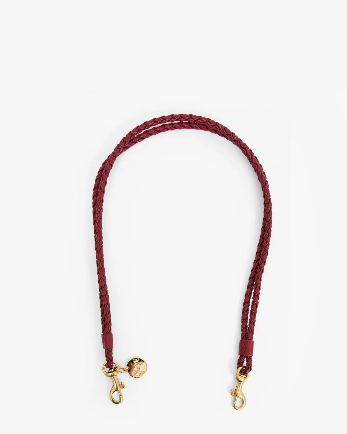 A braided leather shoulder strap in burgundy with gold-tone hardware, including a small decorative charm and two snap hooks, shown on a plain white background.