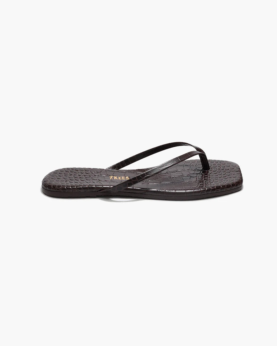 Black sandal with a strap on a white background