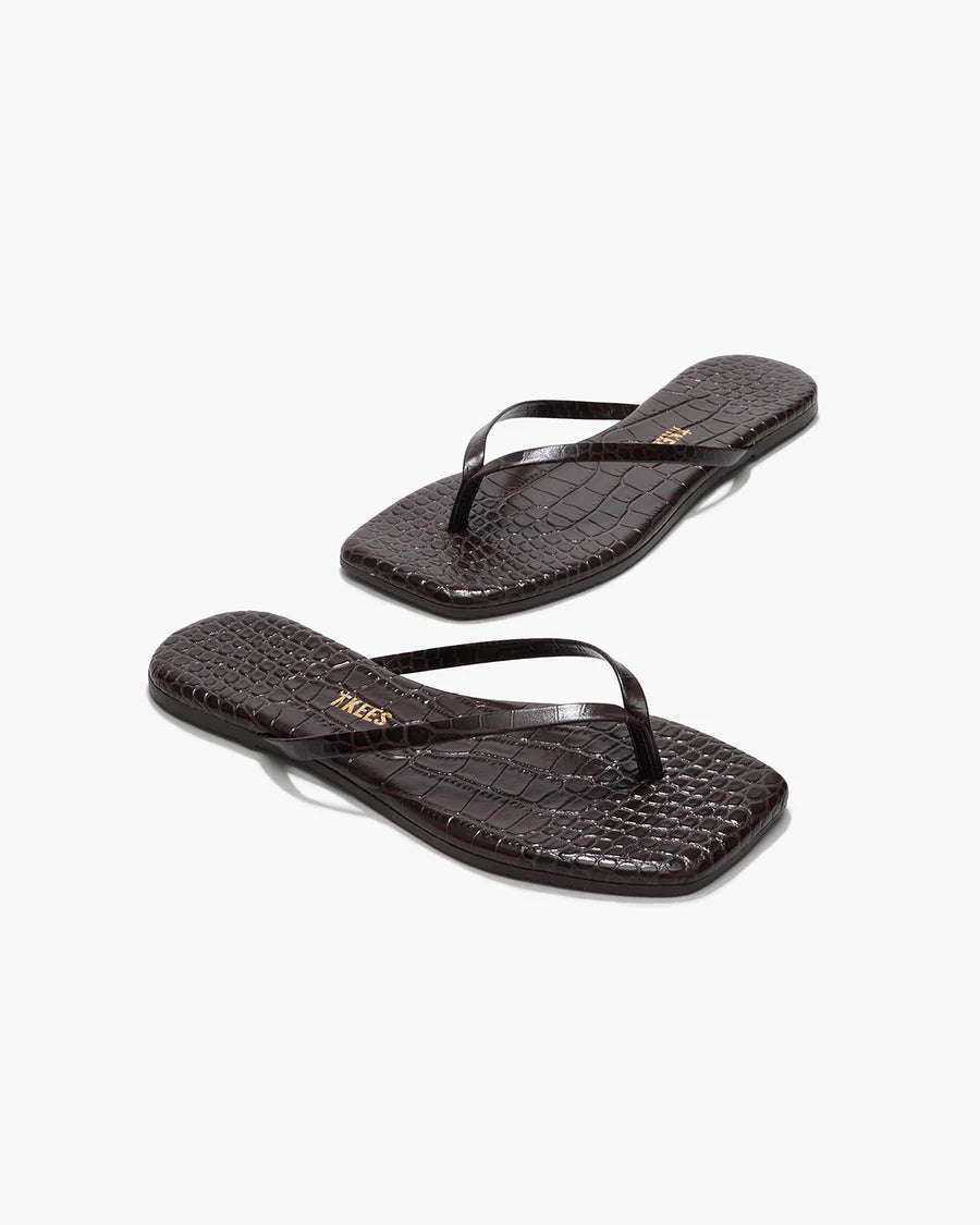 Pair of black flip-flops on a white background