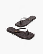 Pair of black flip-flops on a white background
