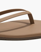 Brown sandal with a strap on a white background