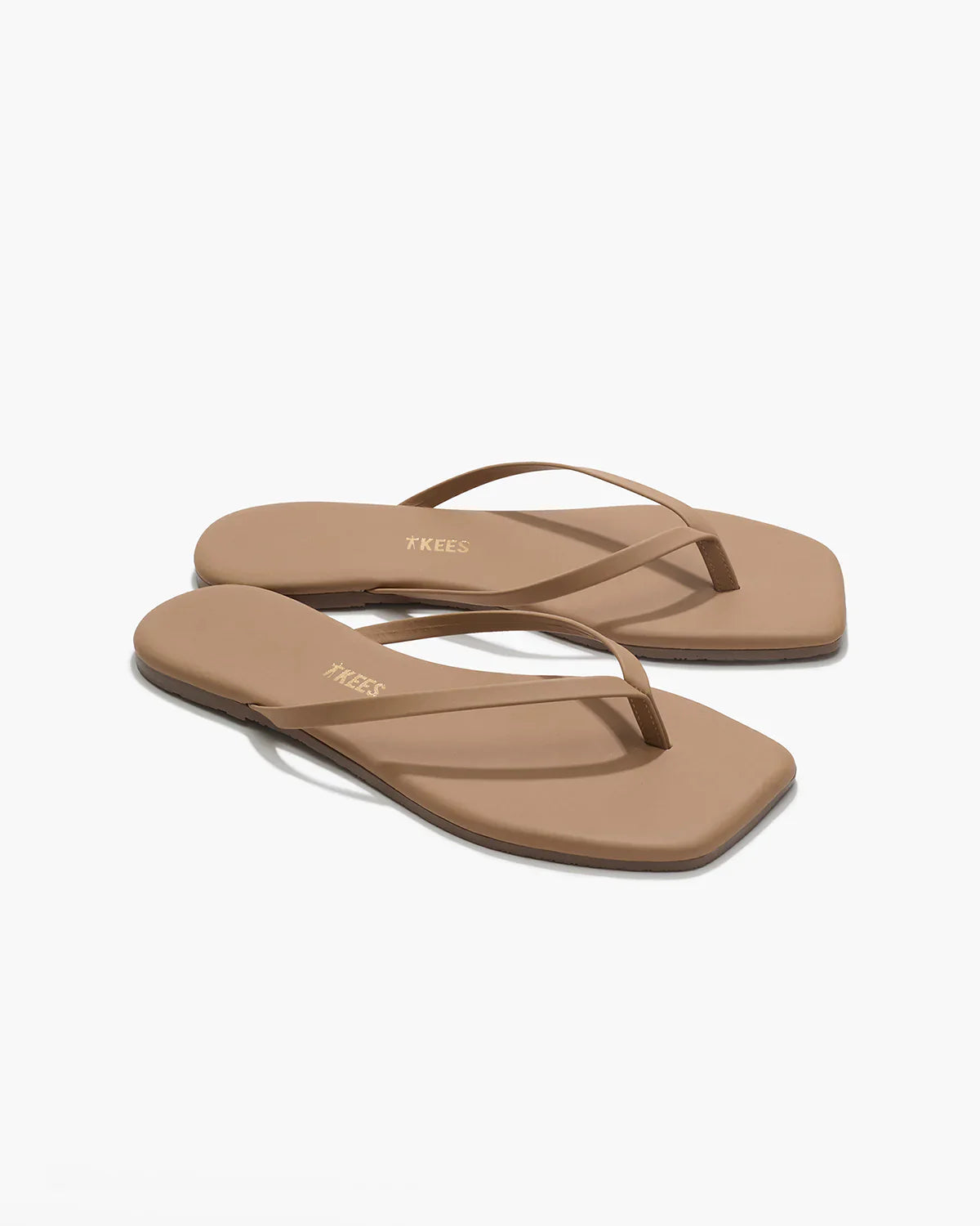 Pair of tan sandals on a white background