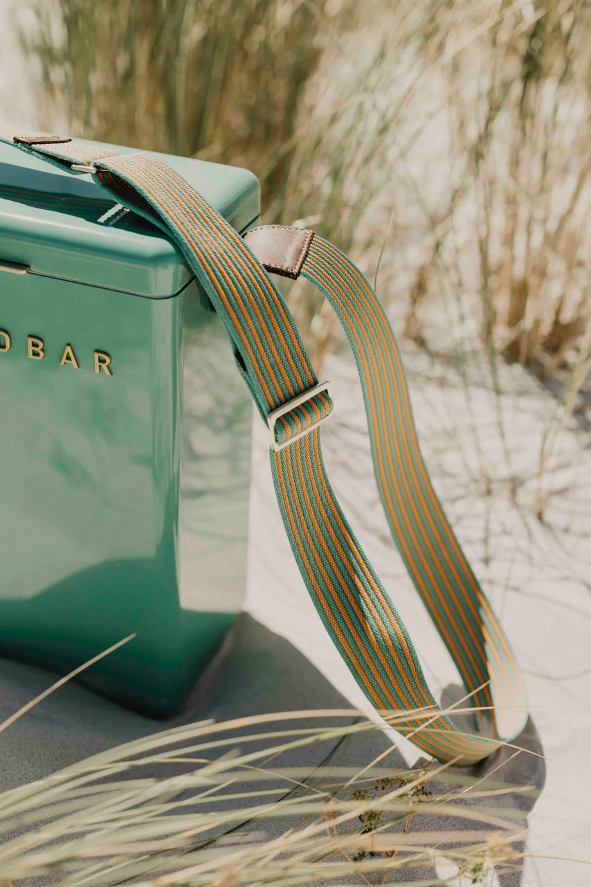 Green bag with a strap on a natural background