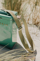Green bag with a strap on a natural background